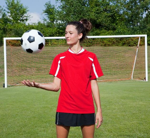 Girl soccer player with ball
