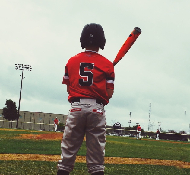 Youth baseball player getting ready to bat during a game.